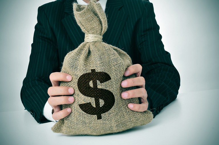Businessman Holding Money Bag
