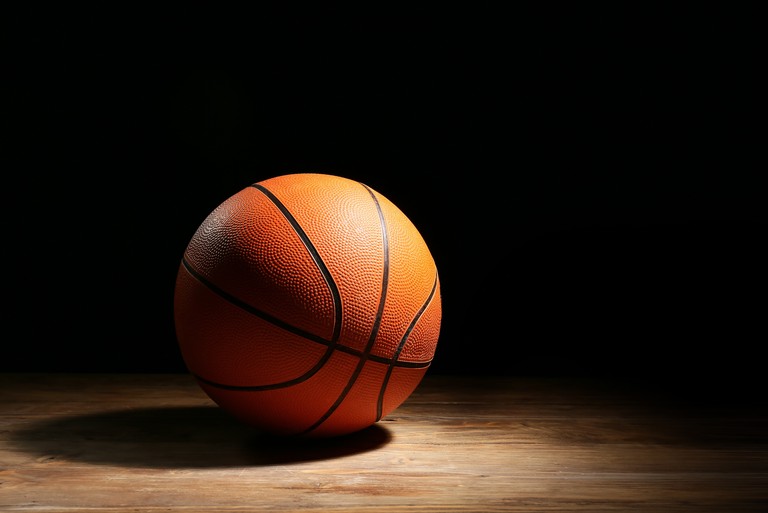 Basketball Under Spotlight on Dark Court