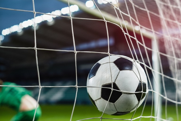 Football Hitting Net Past Goalkeeper