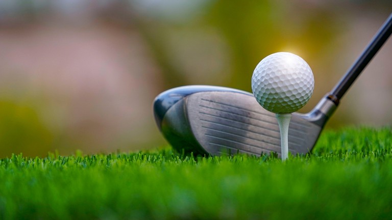 Driver with Golf Ball on White Tee