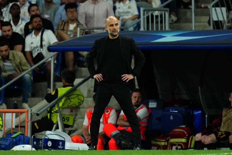 Pep Guardiola standing