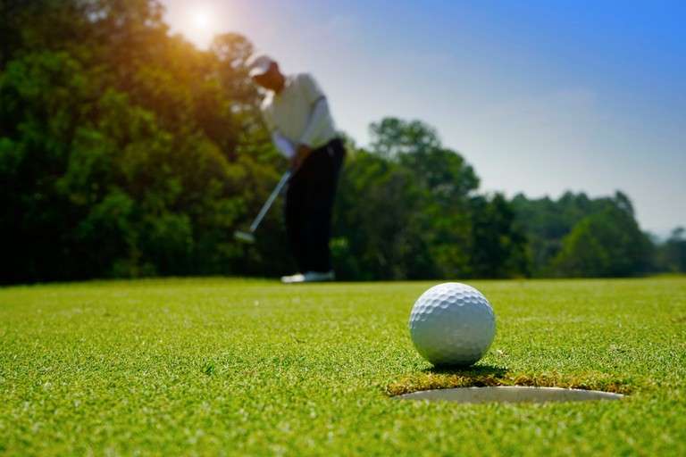 Blurred Golfer Making Putt