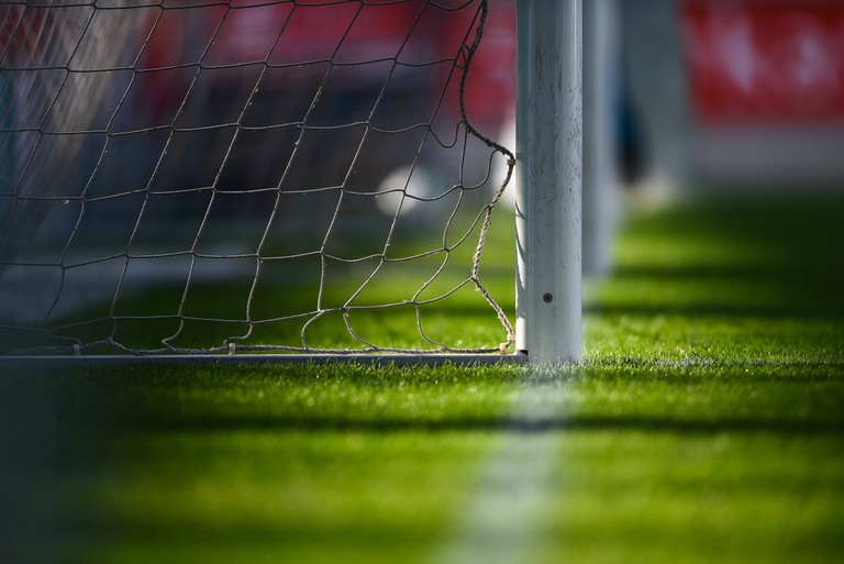 Goal Posts in Stadium with Red Seats